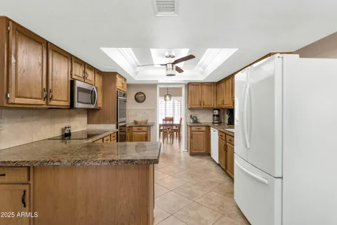 a kitchen with refrigerator cabinets and microwave