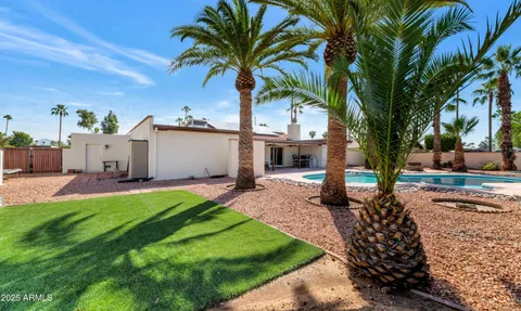 a view of a house with swimming pool and sitting area