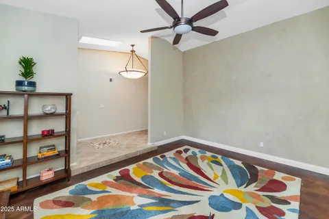 a bedroom with a bed and a painting on the wall