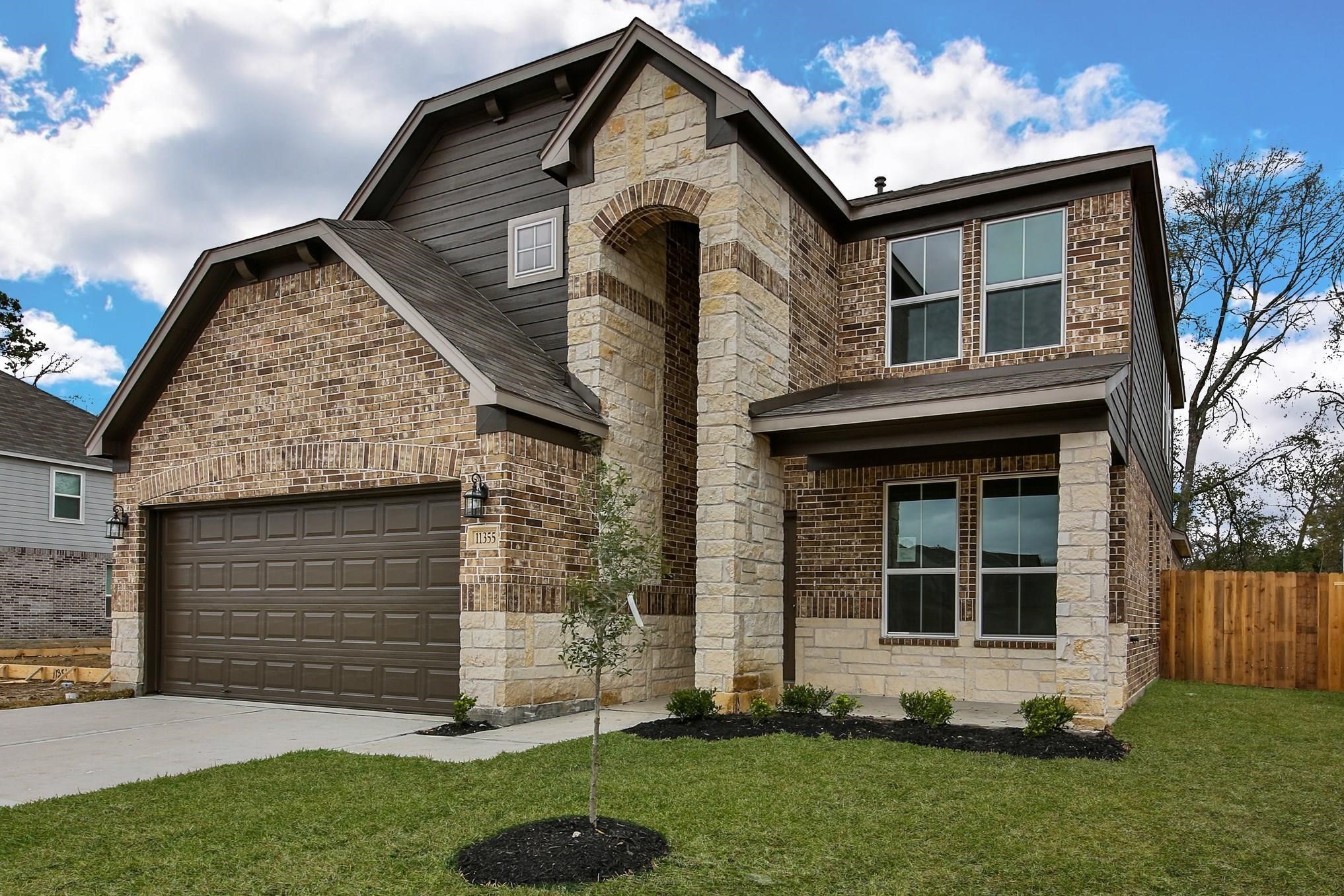 11355 Cascading Stream Way Houston, TX 77044 - Photo 1 of 17 Stunning two-story home featuring a blend of brick and stone exterior, complete with a spacious double garage and well-maintained landscaping.
