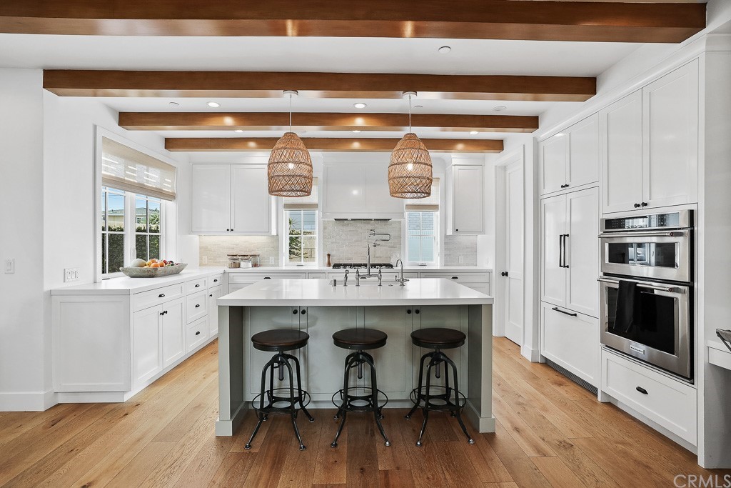 355 Rochester Street Costa Mesa, CA 92627 - Photo 14 of 34 a kitchen with stainless steel appliances a stove a sink and cabinets