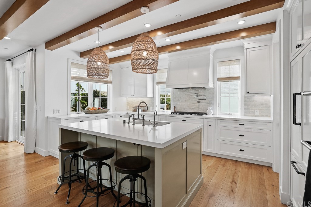 355 Rochester Street Costa Mesa, CA 92627 - Photo 15 of 34 a kitchen with a sink stove and cabinets