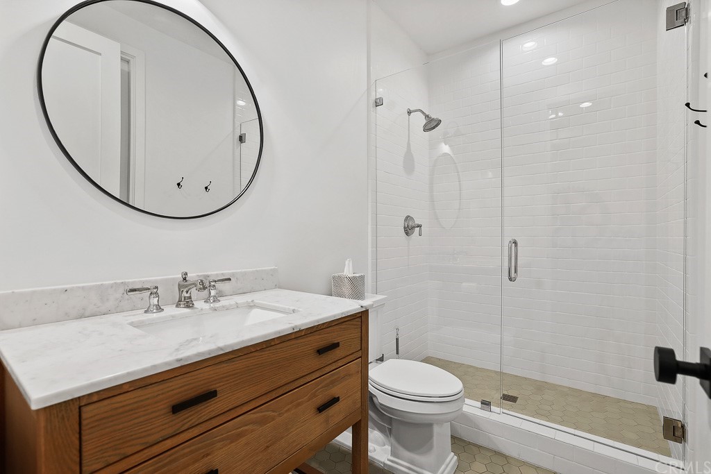355 Rochester Street Costa Mesa, CA 92627 - Photo 18 of 34 a bathroom with a sink a toilet and a mirror
