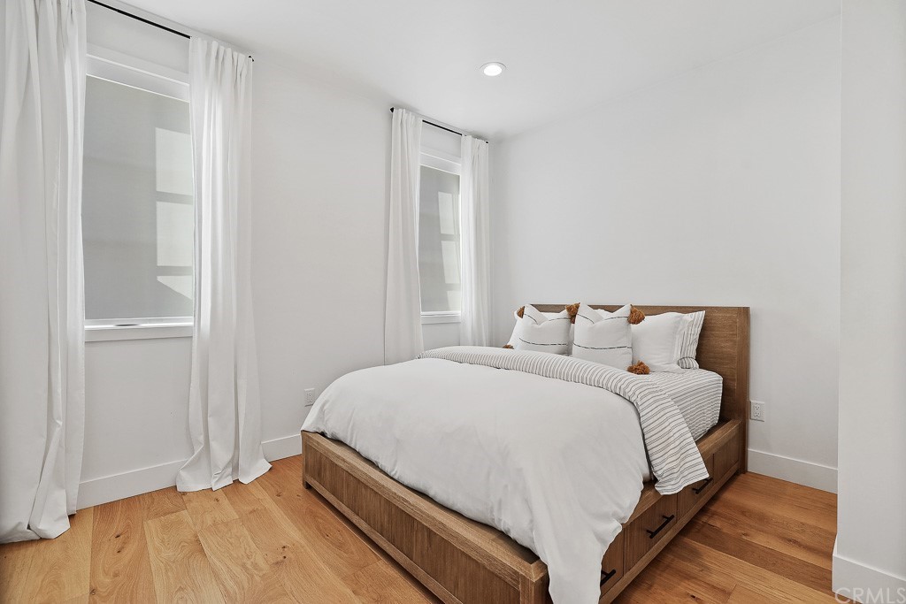 355 Rochester Street Costa Mesa, CA 92627 - Photo 19 of 34 a bedroom with a bed and a mirror