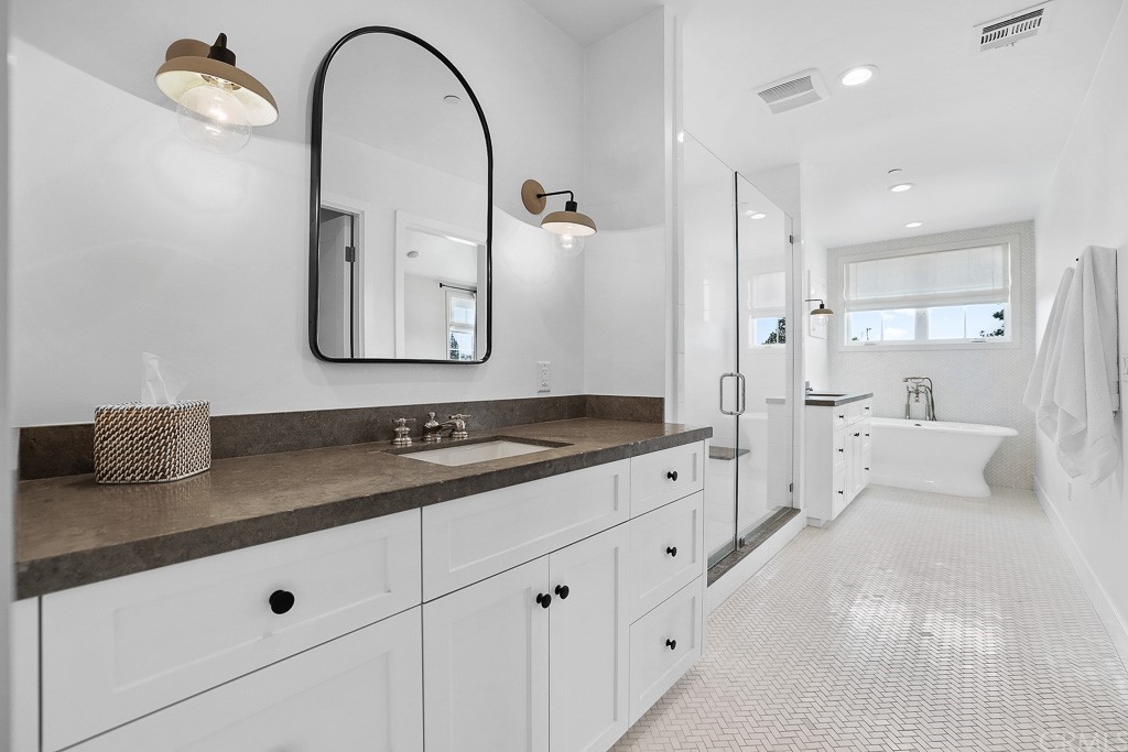 355 Rochester Street Costa Mesa, CA 92627 - Photo 24 of 34 a spacious bathroom with a double vanity sink and mirror