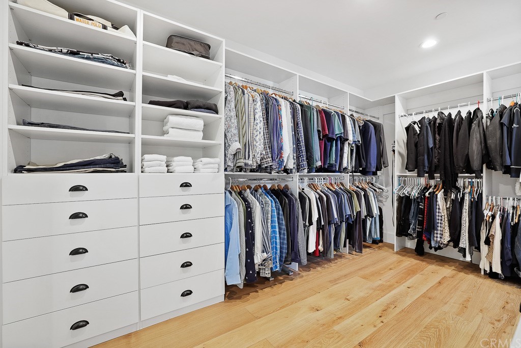 355 Rochester Street Costa Mesa, CA 92627 - Photo 26 of 34 a view of walk in closet with clothes and shoes