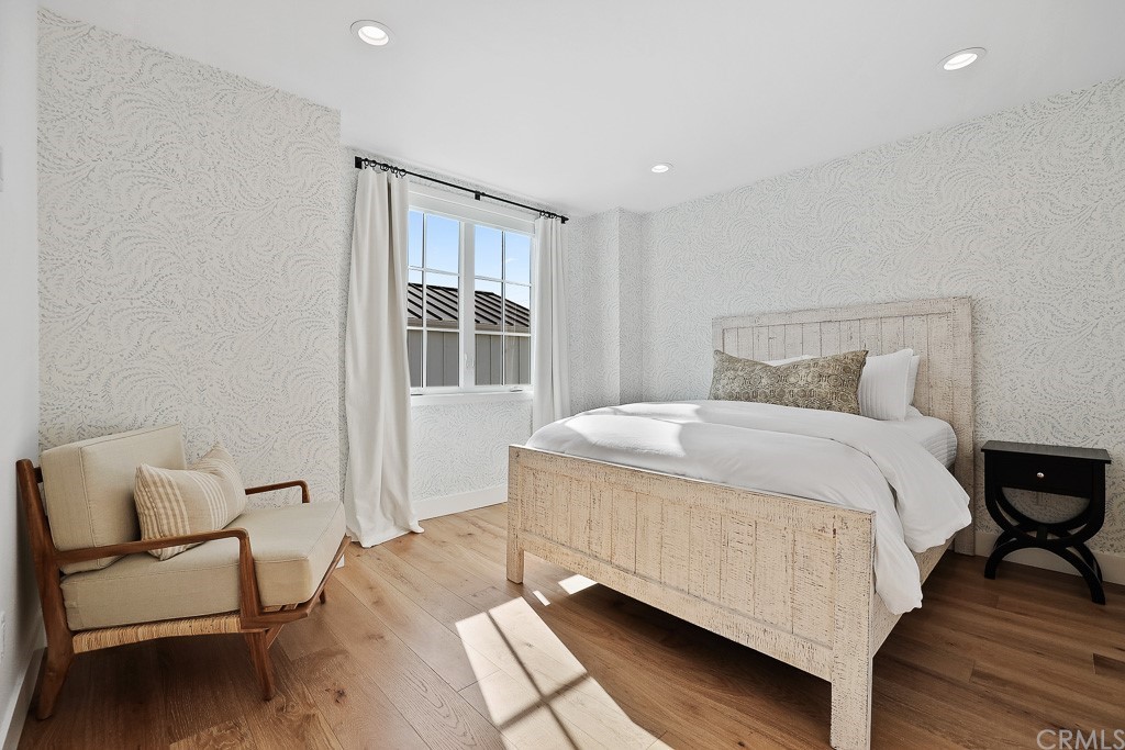 355 Rochester Street Costa Mesa, CA 92627 - Photo 27 of 34 a bedroom with a bed and wooden floor