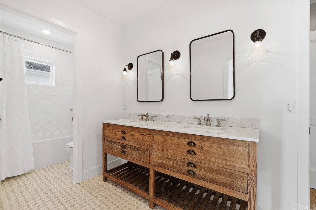 355 Rochester Street Costa Mesa, CA 92627 - Photo 28 of 34 a bathroom with a double vanity sink mirror and