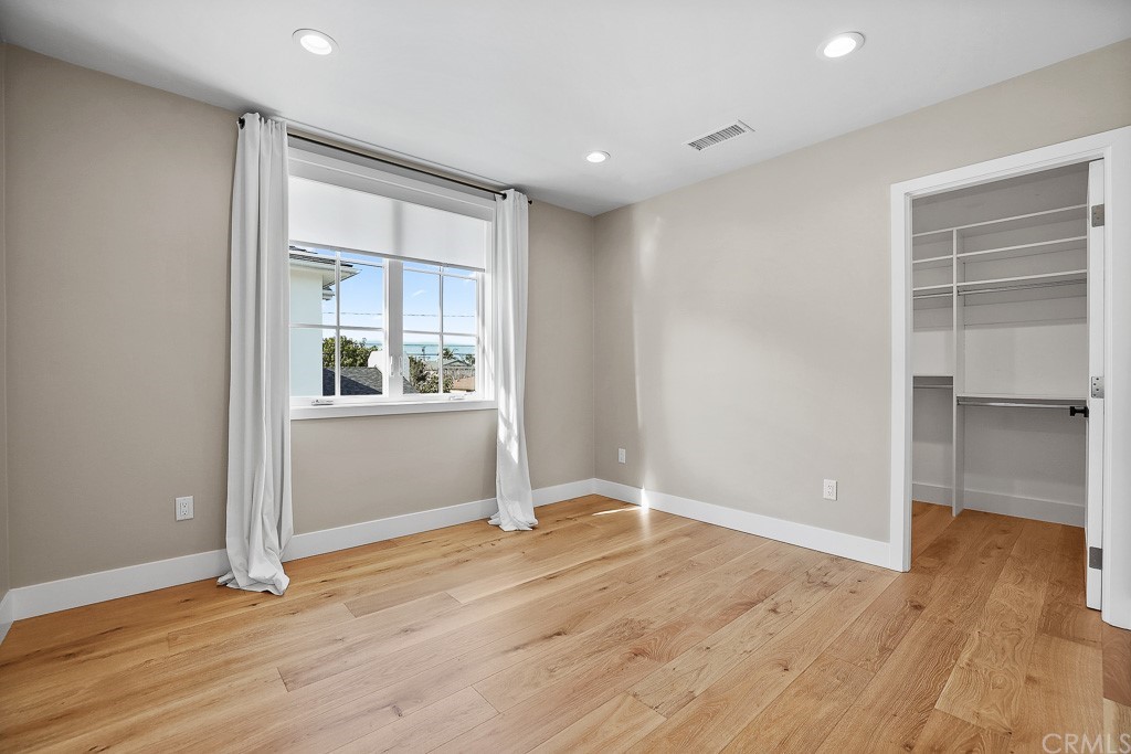 355 Rochester Street Costa Mesa, CA 92627 - Photo 30 of 34 an empty room with wooden floor and windows