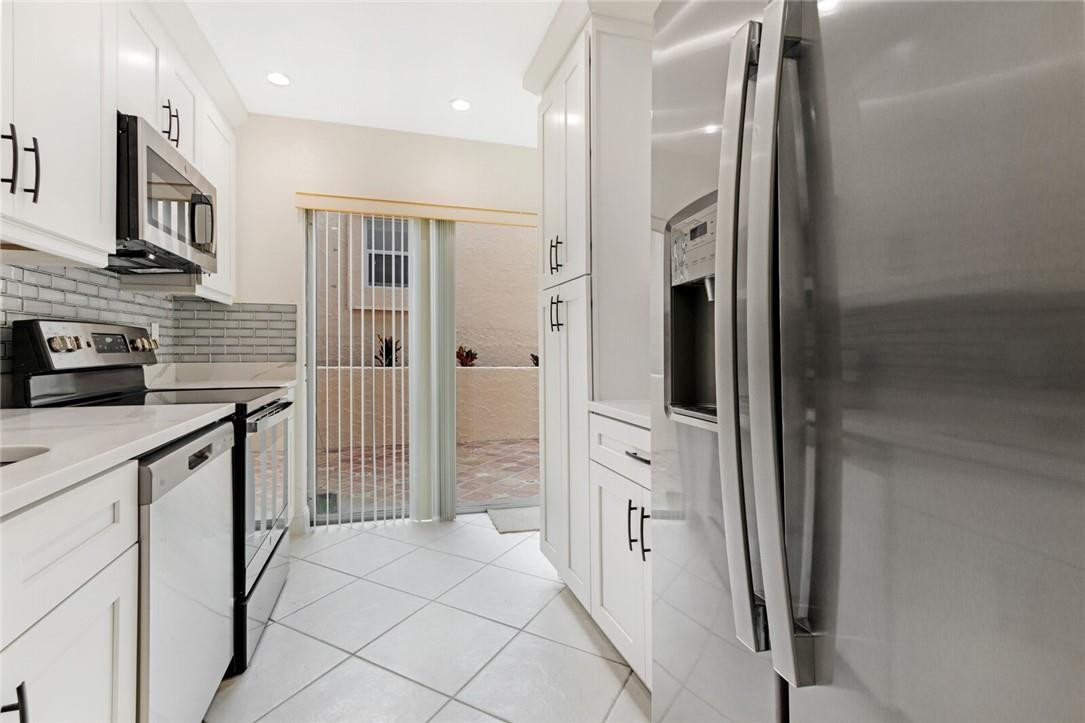 3420 Spring Bluff Place, Unit 39 Lauderhill, FL 33319 - Photo 11 of 32 a kitchen with stainless steel appliances a refrigerator and a sink