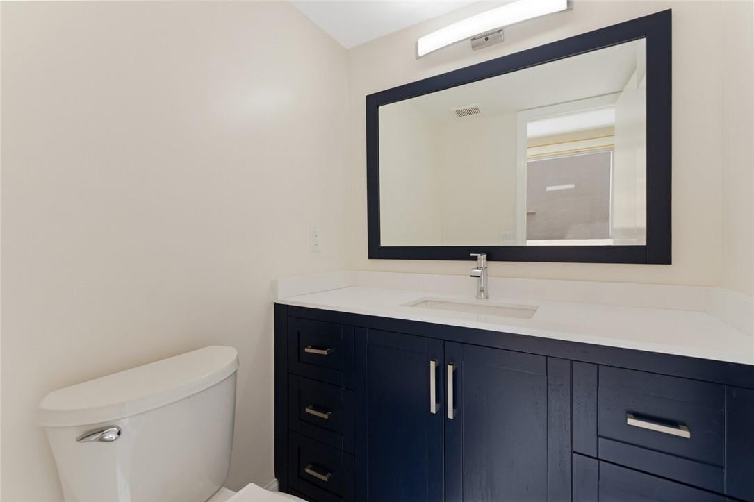 3420 Spring Bluff Place, Unit 39 Lauderhill, FL 33319 - Photo 15 of 32 a bathroom with a toilet sink and mirror
