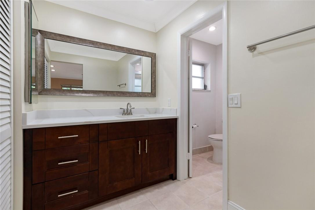 3420 Spring Bluff Place, Unit 39 Lauderhill, FL 33319 - Photo 19 of 32 a bathroom with a sink vanity and a mirror