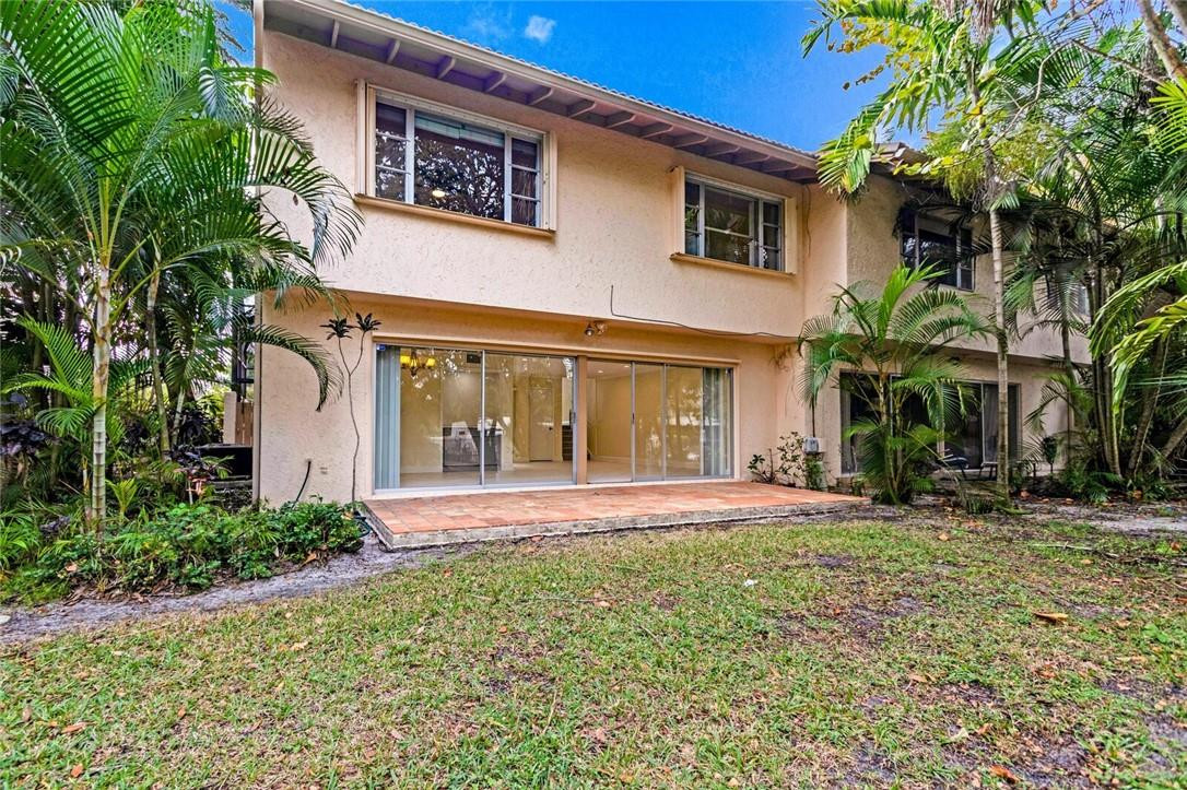 3420 Spring Bluff Place, Unit 39 Lauderhill, FL 33319 - Photo 29 of 32 a front view of a house with a garden