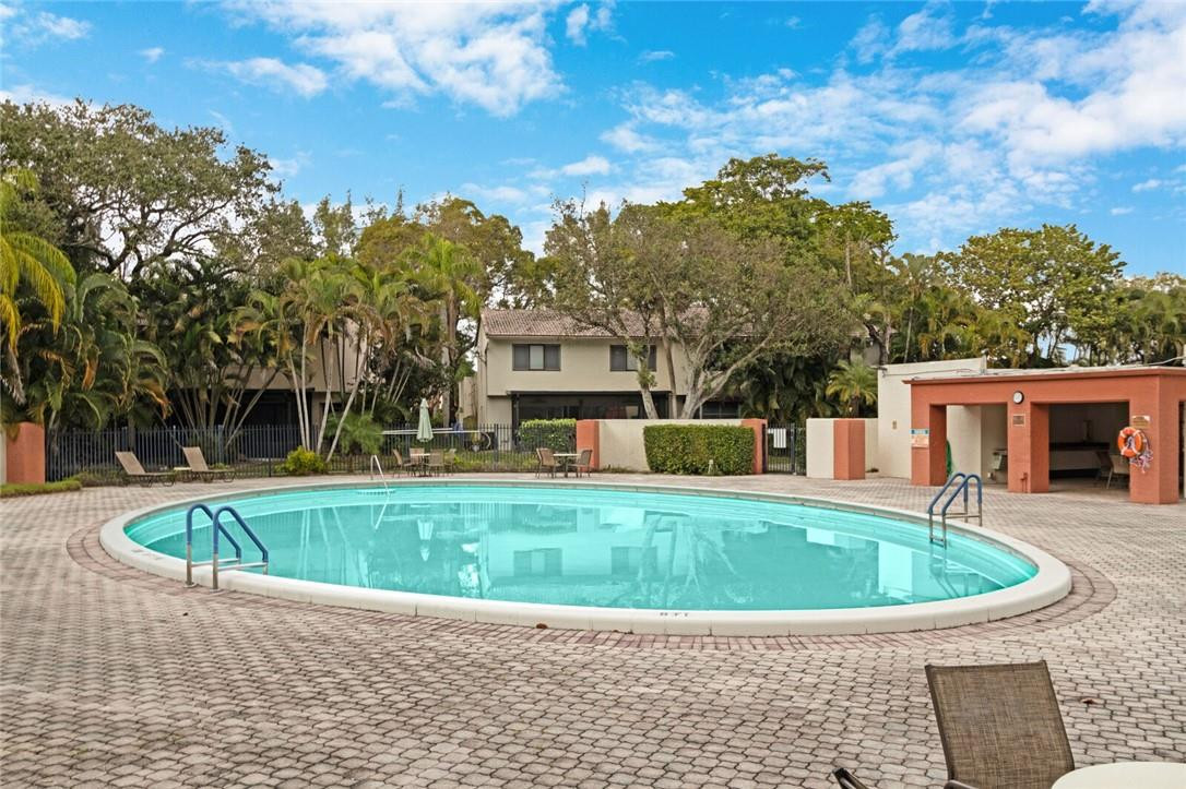 3420 Spring Bluff Place, Unit 39 Lauderhill, FL 33319 - Photo 30 of 32 a view of a house with a swimming pool and sitting area