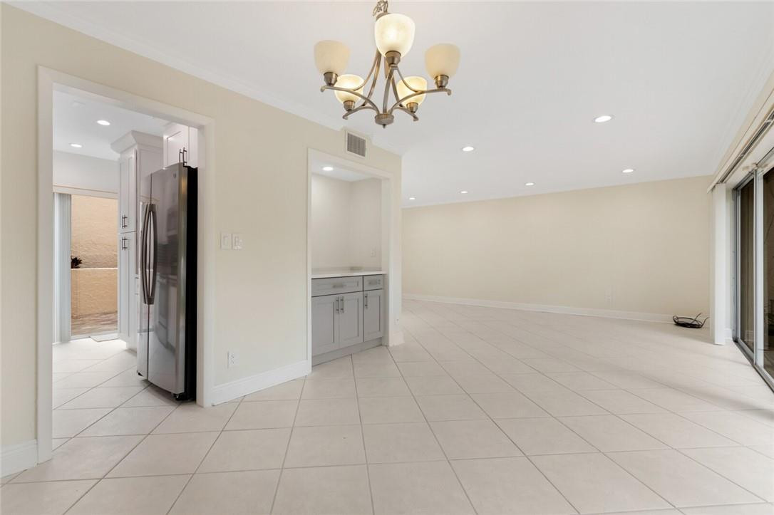 3420 Spring Bluff Place, Unit 39 Lauderhill, FL 33319 - Photo 7 of 32 a view of a livingroom with a chandelier furniture and kitchen view