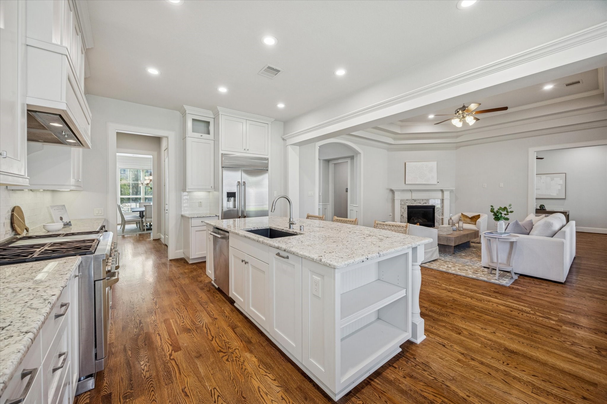 1802 Wakefield Drive Houston, TX 77018 - Photo 20 of 47 Kitchen island with generous storage, including cabinets and open shelving for easy access and stylish organization.