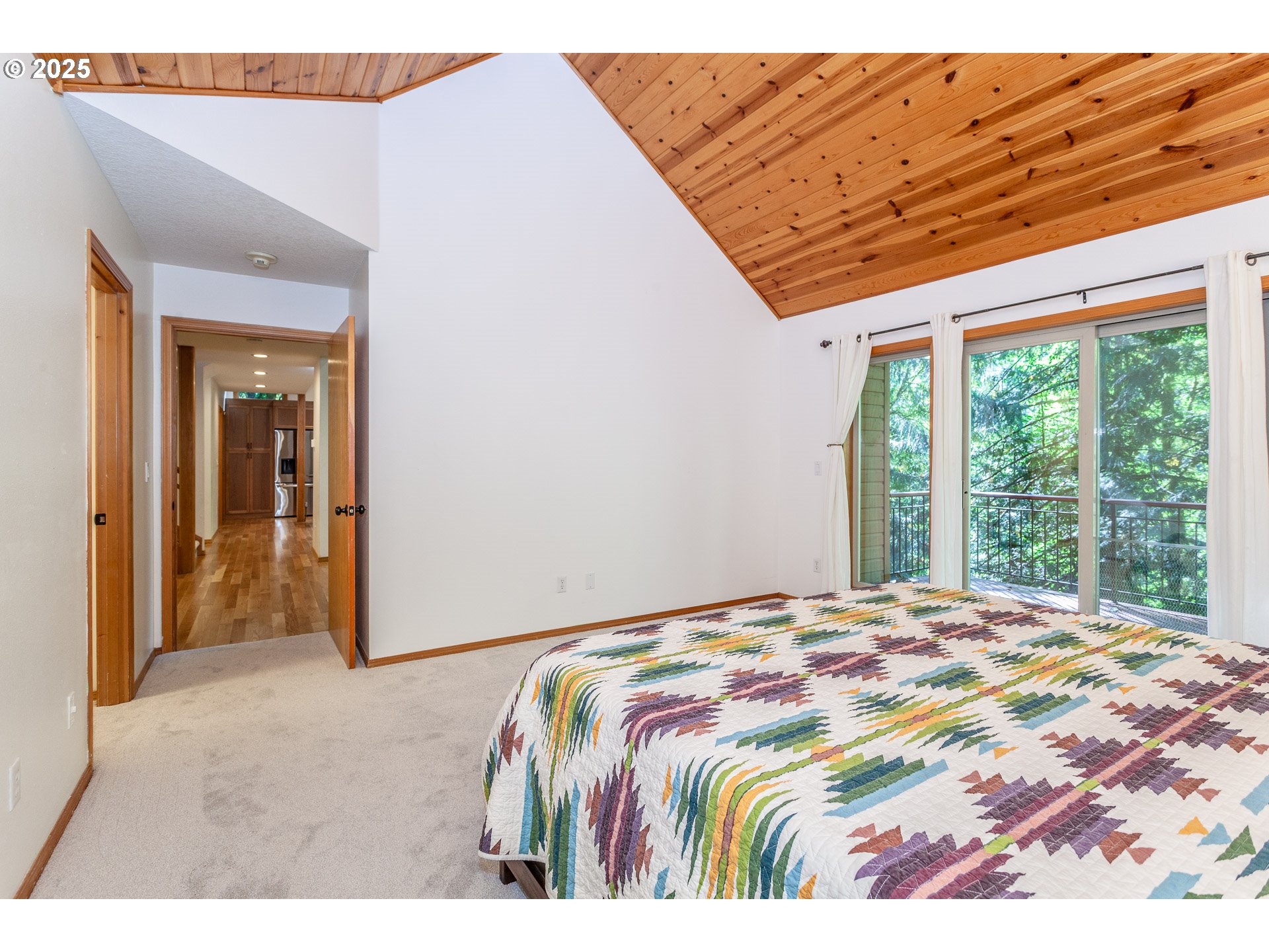 29409 East Edgewater Drive Welches, OR 97067 - Photo 14 of 48 a bedroom with a bed and a large window