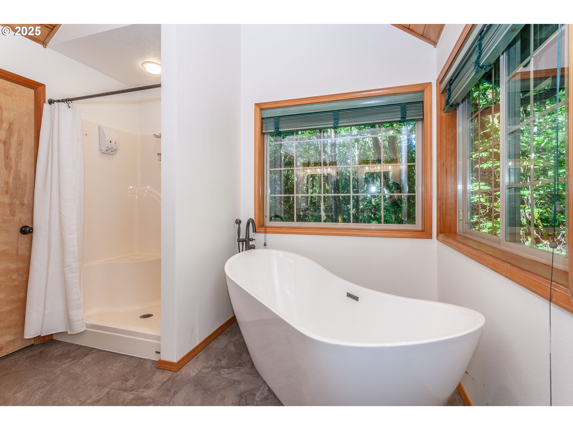 29409 East Edgewater Drive Welches, OR 97067 - Photo 16 of 48 a white bath tub sitting in a bathroom next to a window