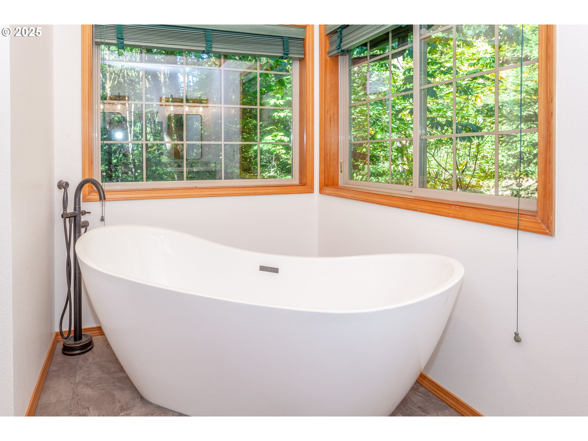 29409 East Edgewater Drive Welches, OR 97067 - Photo 17 of 48 a white bath tub sitting in a bathroom next to a window