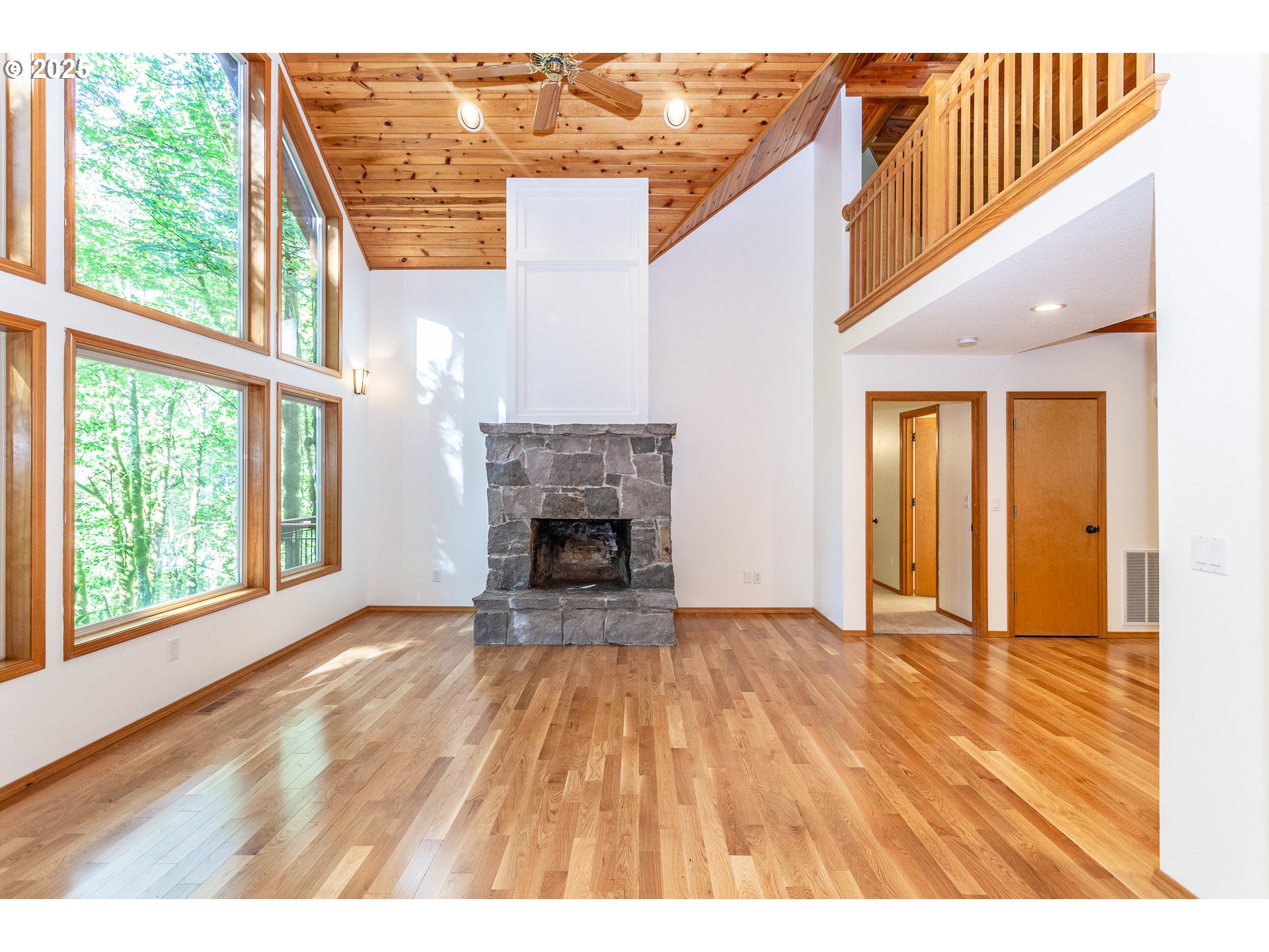 29409 East Edgewater Drive Welches, OR 97067 - Photo 3 of 48 a view of empty room with fireplace and wooden floor