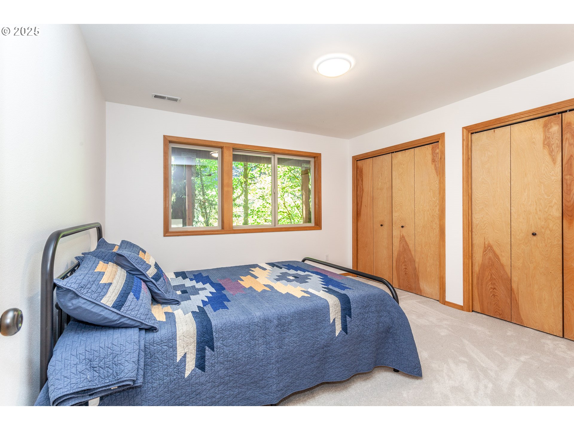 29409 East Edgewater Drive Welches, OR 97067 - Photo 34 of 48 a bed sitting in a bedroom next to a window