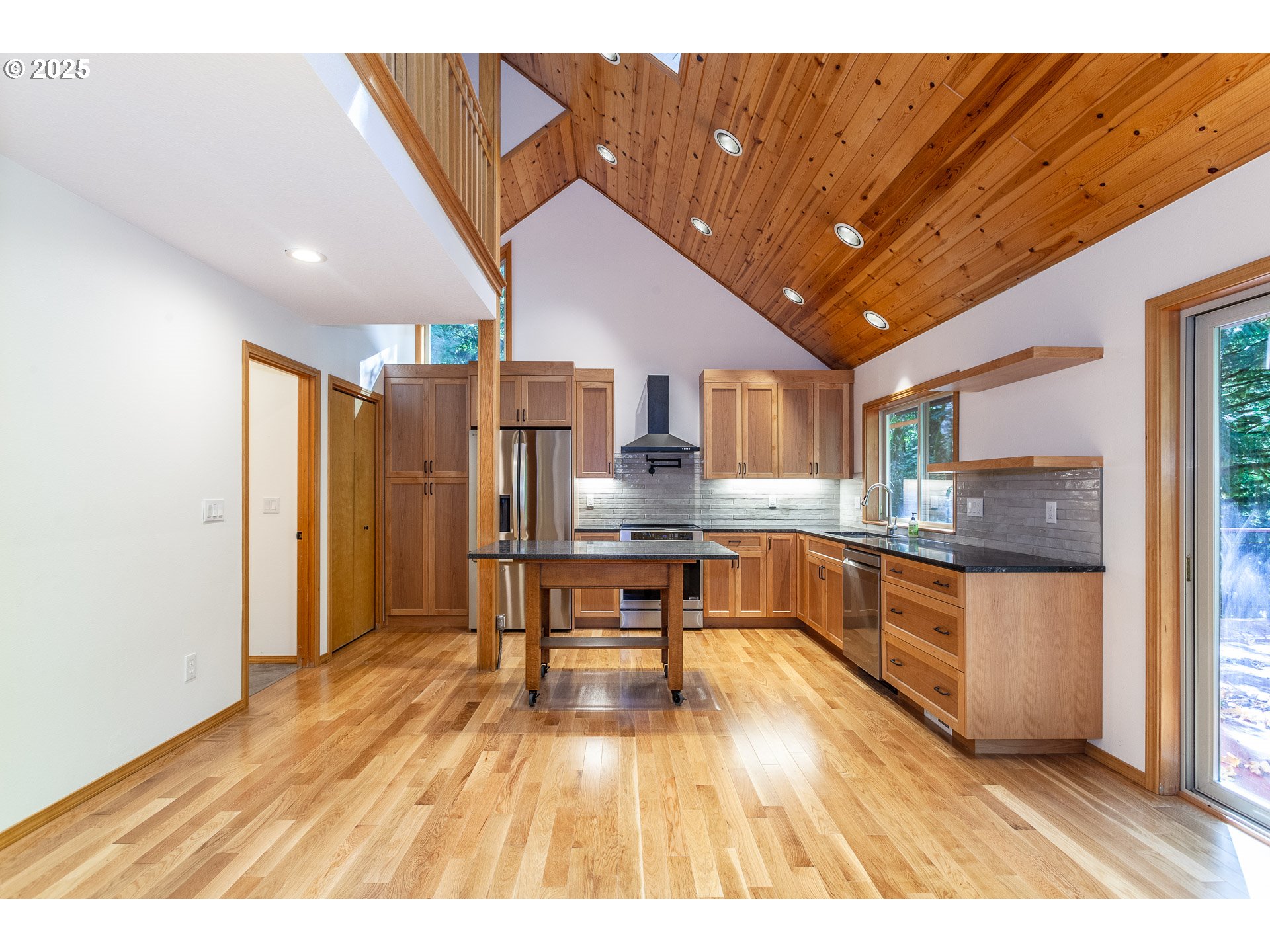 29409 East Edgewater Drive Welches, OR 97067 - Photo 5 of 48 a kitchen with stainless steel appliances granite countertop a refrigerator a microwave oven a sink with island and chairs