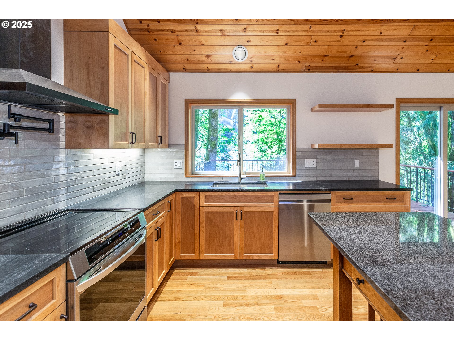 29409 East Edgewater Drive Welches, OR 97067 - Photo 8 of 48 a kitchen with stainless steel appliances granite countertop a sink a stove and a microwave