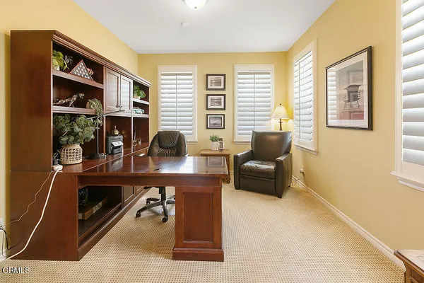 a dining room with furniture and a large window