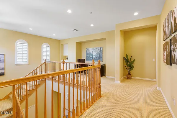 a spacious bathroom with a tub sink and mirror