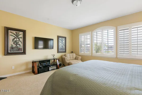 a bedroom with a bed and windows