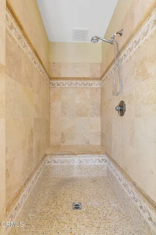 a bedroom with a bed and a chair