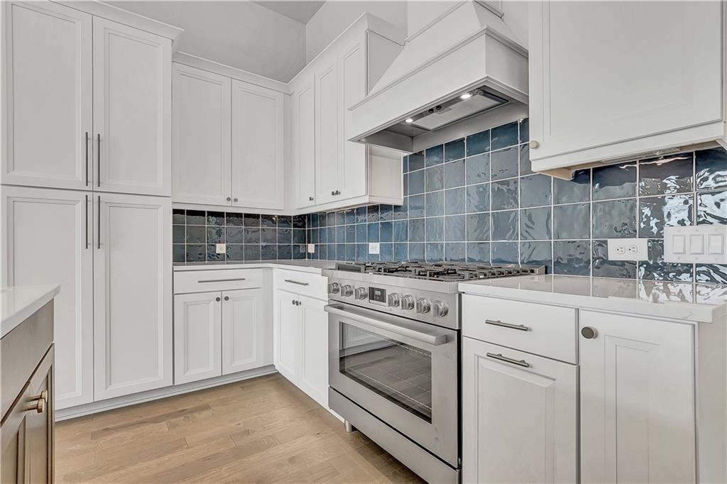 180 Rolison Way Fayetteville, GA 30214 - Photo 11 of 55 a kitchen with white cabinets and white appliances