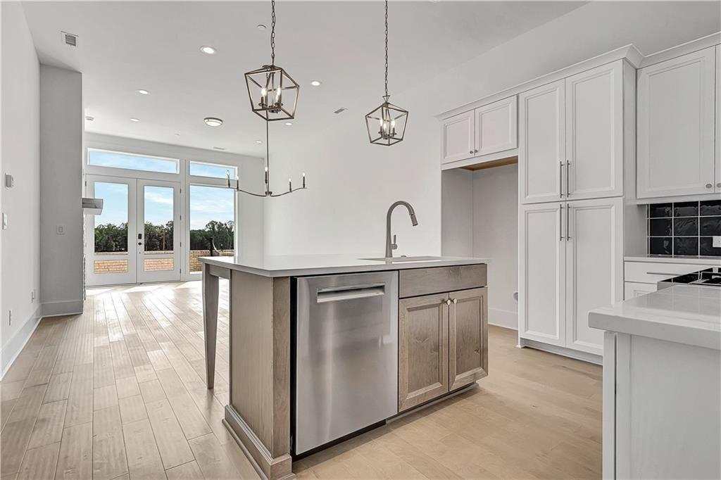 180 Rolison Way Fayetteville, GA 30214 - Photo 12 of 55 a kitchen with kitchen island granite countertop a stove a sink and a refrigerator with wooden floor