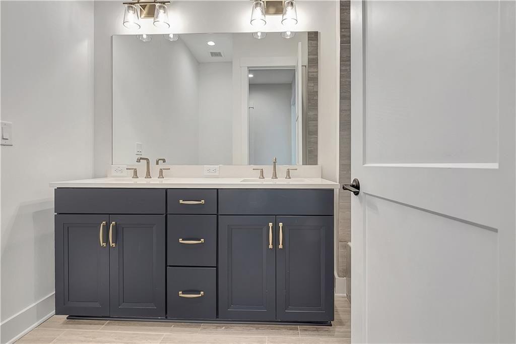 180 Rolison Way Fayetteville, GA 30214 - Photo 31 of 55 a bathroom with a sink vanity and mirror