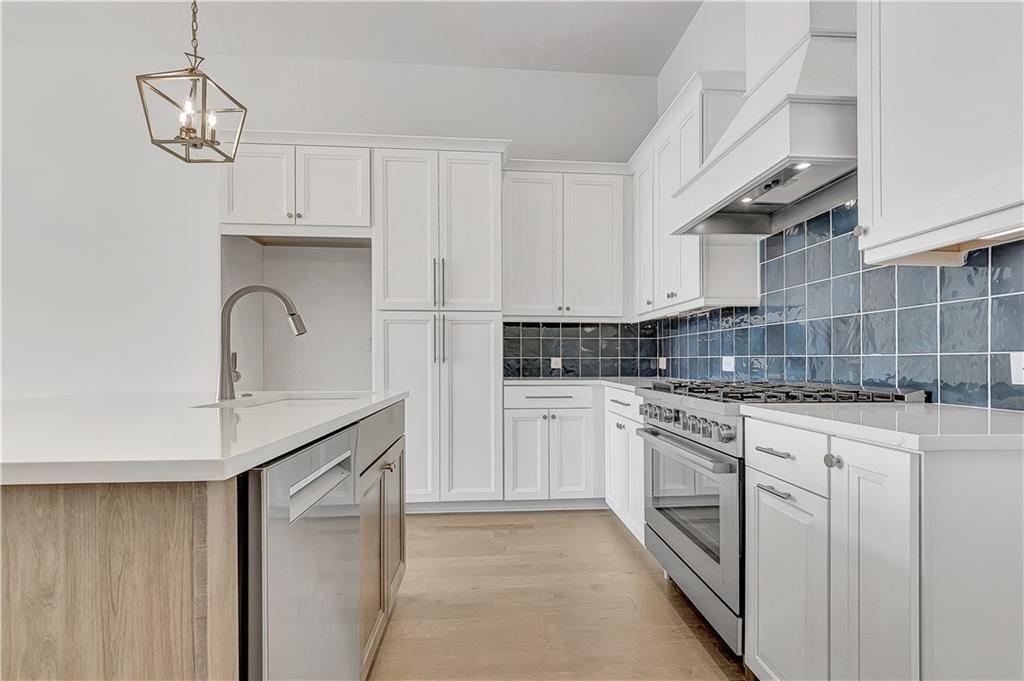 180 Rolison Way Fayetteville, GA 30214 - Photo 10 of 55 a kitchen with stainless steel appliances granite countertop a sink a stove and refrigerator