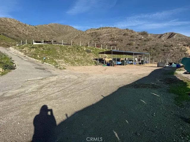 a view of a dry yard with mountains in the background