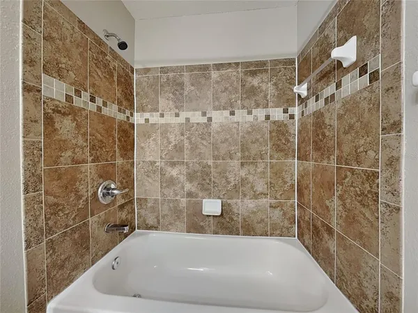 a bath tub sitting next to a shower