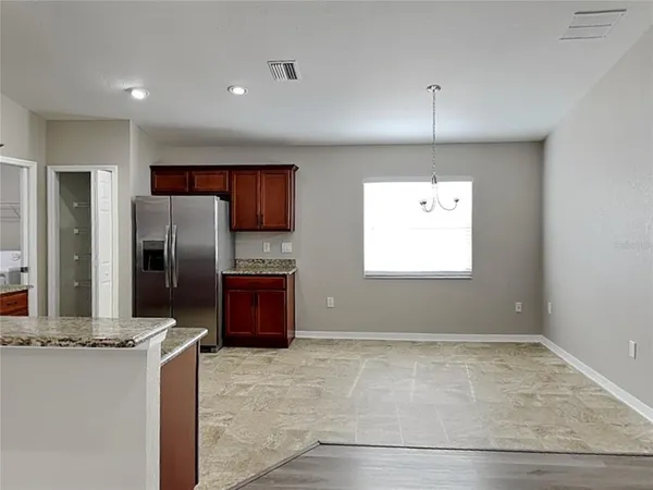 a kitchen with stainless steel appliances granite countertop a refrigerator and a sink