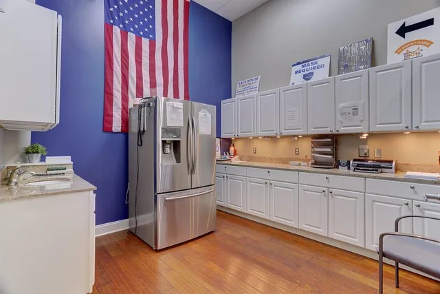 a kitchen with stainless steel appliances granite countertop a refrigerator sink and cabinets