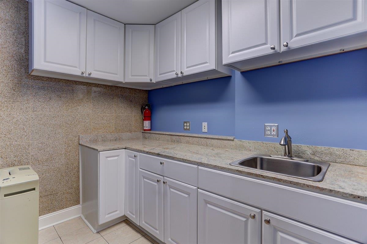 95 South Main Street, Unit 102 Memphis, TN 38103 - Photo 16 of 35 a kitchen with stainless steel appliances granite countertop a sink and cabinets
