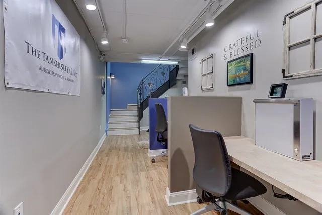 a view of a hallway with wooden floor and staircase