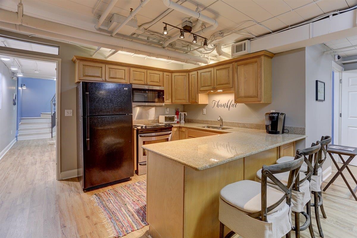 95 South Main Street, Unit 102 Memphis, TN 38103 - Photo 23 of 35 a kitchen with stainless steel appliances granite countertop a sink and a refrigerator