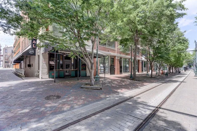 a view of a house with a tree in front