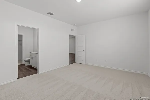 a view of a room with a walk in closet and wooden floor