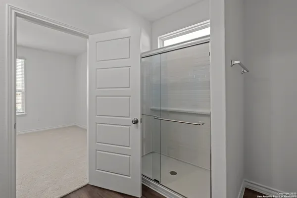 a bathroom with a glass shower door