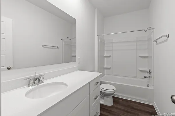 a bathroom with a granite countertop toilet a sink and a bathtub