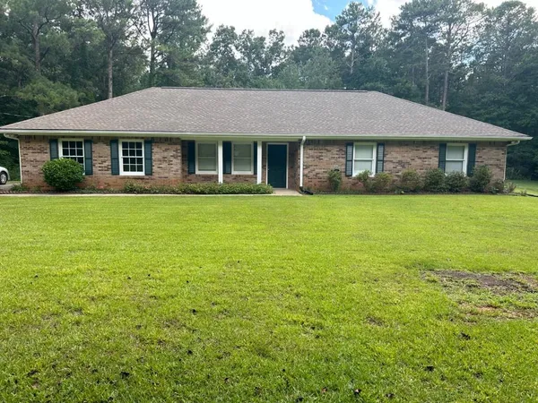 a aerial view of a house next to a big yard