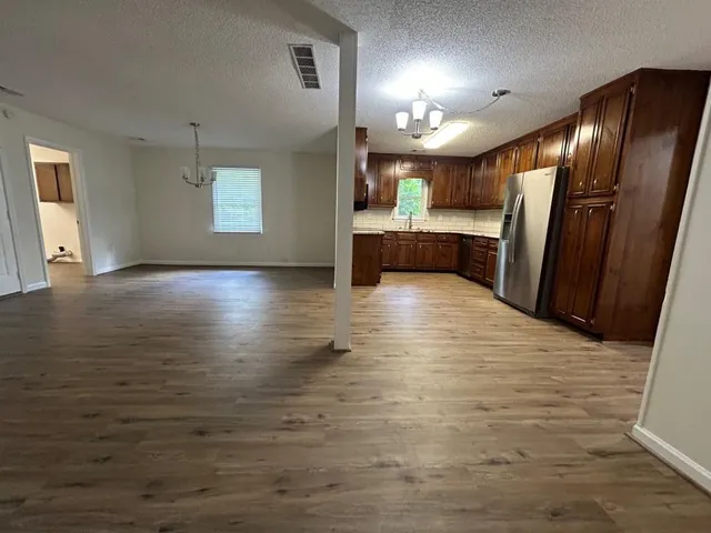 a view of a kitchen with a sink and a refrigerator