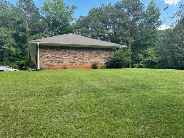 a view of a wooden deck with a yard