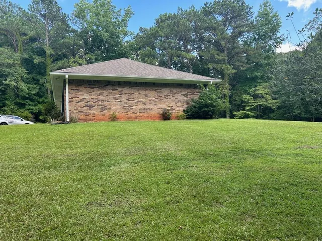 a view of a wooden deck with a yard